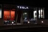 Electrc vehicles stands on display inside a Tesla Inc. store in Bern, Switzerland.