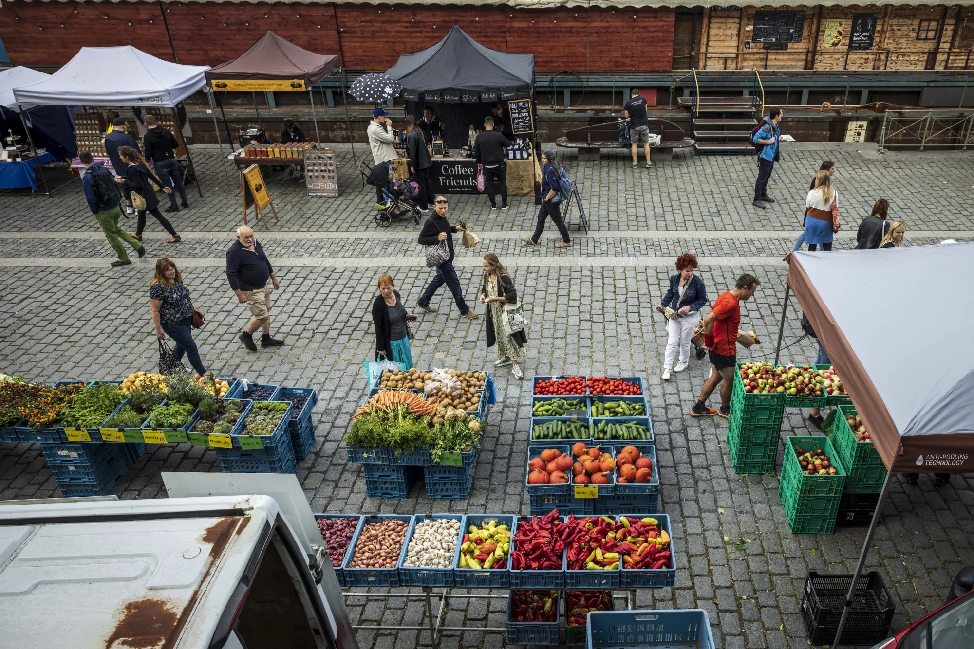 Customers shop at fruit and vegetable stalls in Prague.