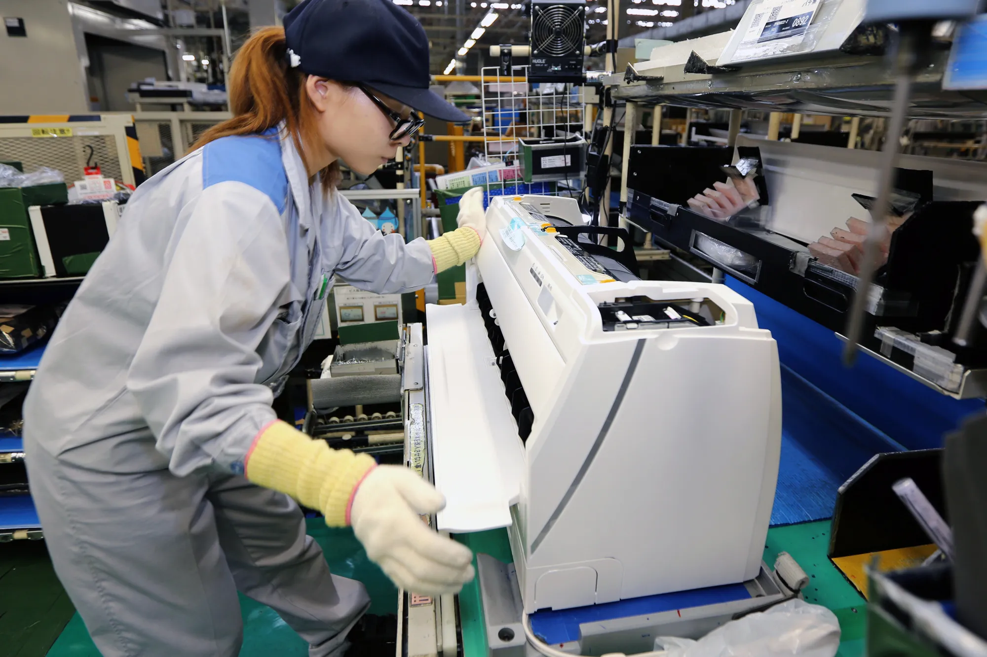 A worker assembles a Daikin Industries Ltd. split type air conditioner on the production line&nbsp;in Kusatsu, Shiga, Japan.