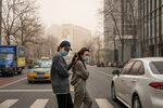 Pedestrians in Beijing, which was shrouded in polluted air after a sandstorm in March 2021. 