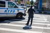 An NYPD officer monitors the crime scene at a shooting in the 73th precinct in Brownsville, Brooklyn.