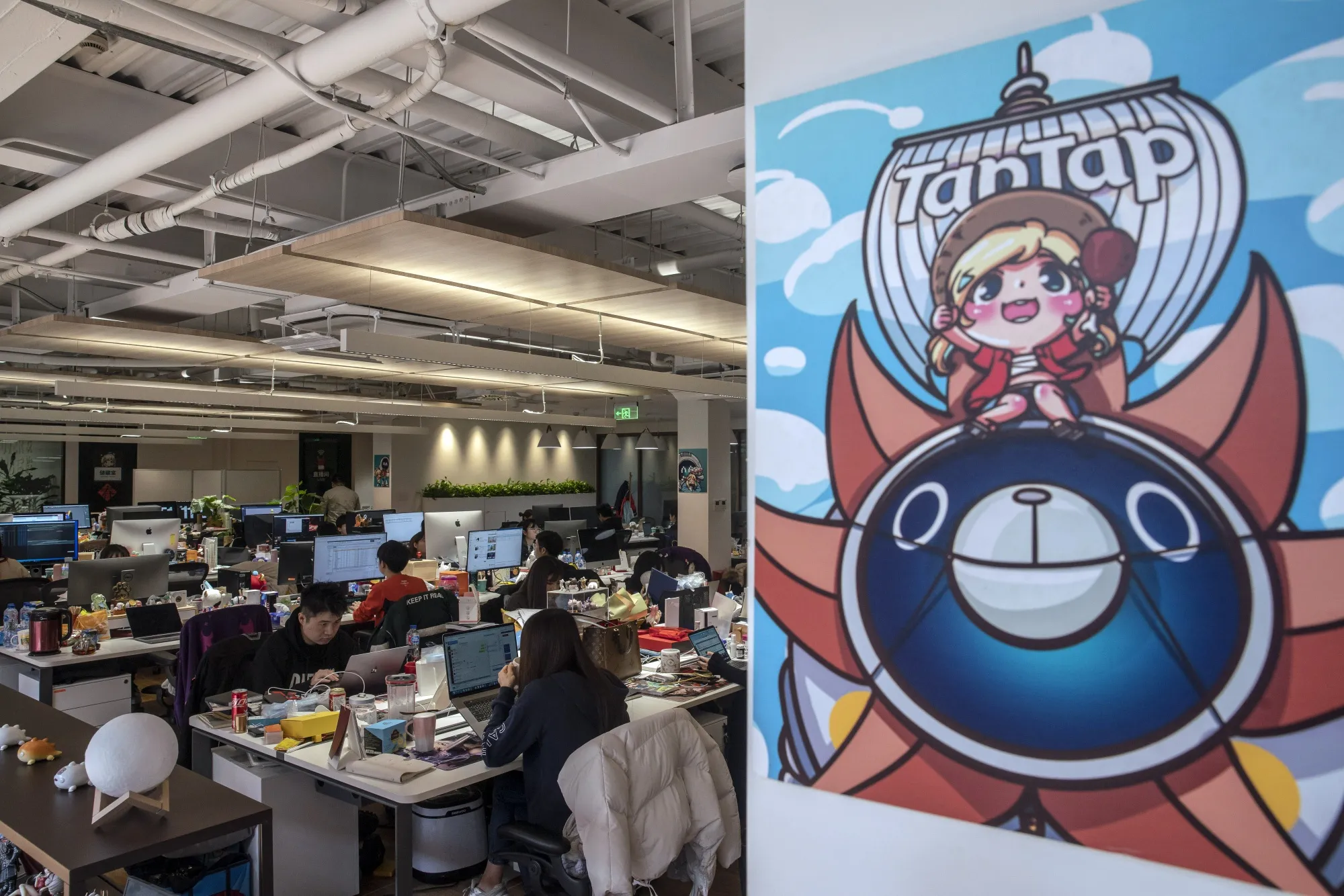Employees work at XD Inc.'s Tap Tap office in Shanghai, China.
