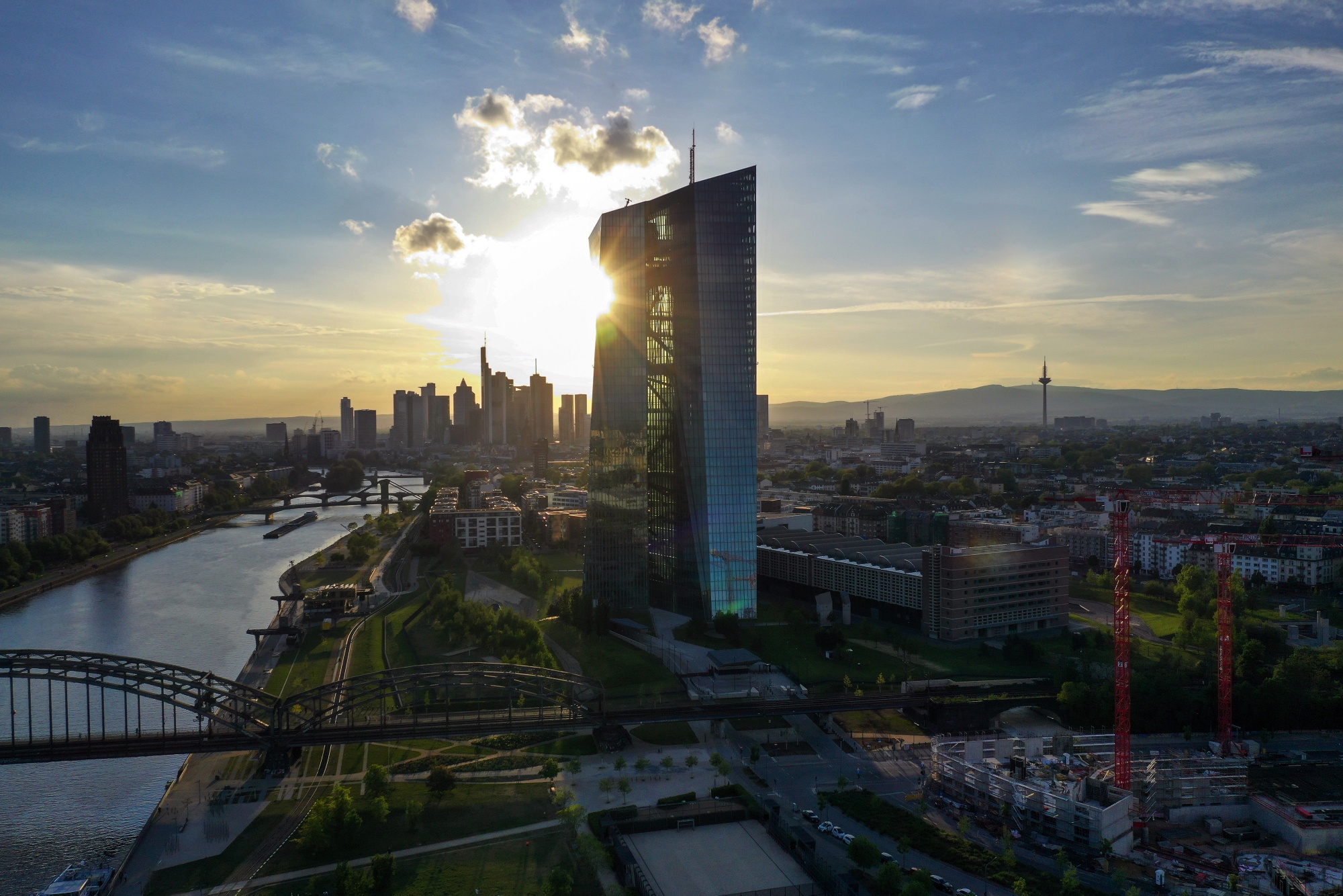The setting sun reflects off the European Central Bank headquarters&nbsp;in Frankfurt.