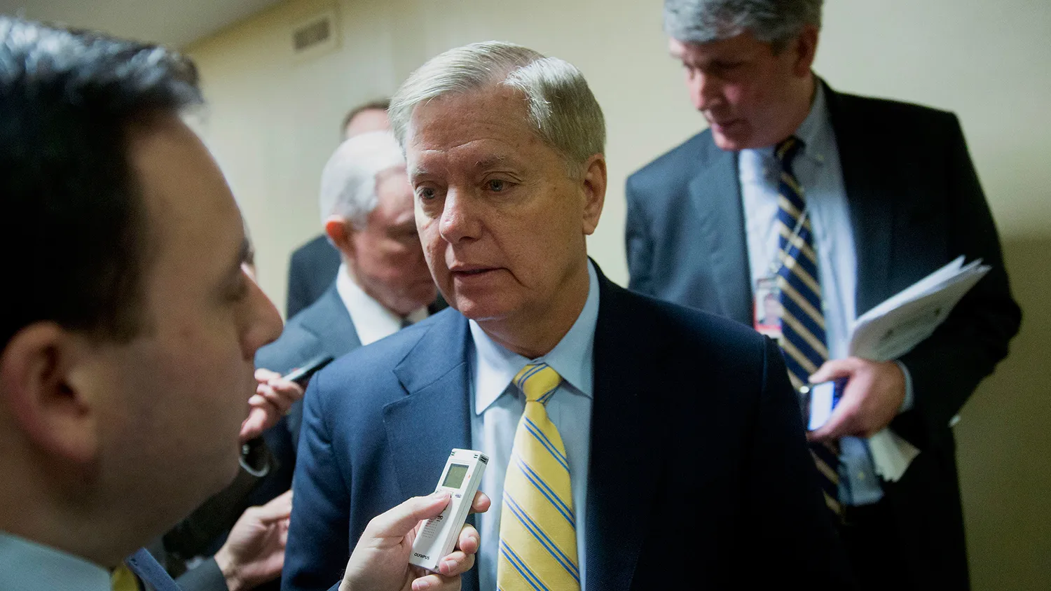 Senator Lindsey Graham, a Republican from South Carolina, speaks to reporters in the U.S. Capitol Building basement before voting in Washington, D.C., U.S., on Tuesday, Dec. 9, 2014.
