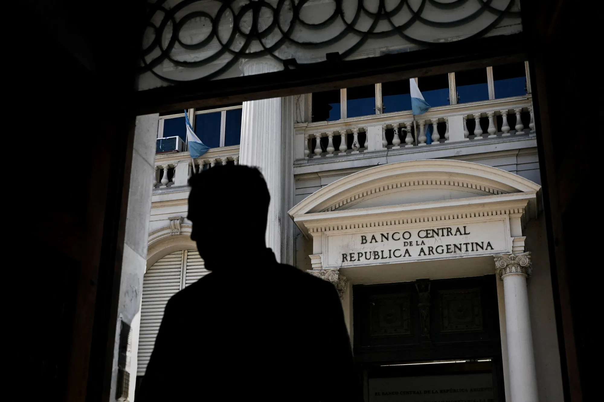 A person stands in front of Argentina's Central Bank in Buenos Aires.&nbsp;