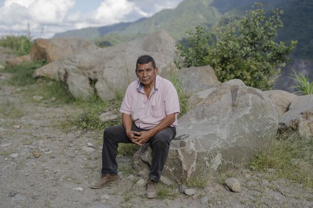 A portrait of Marco Cahuatijo sitting on a rock. 