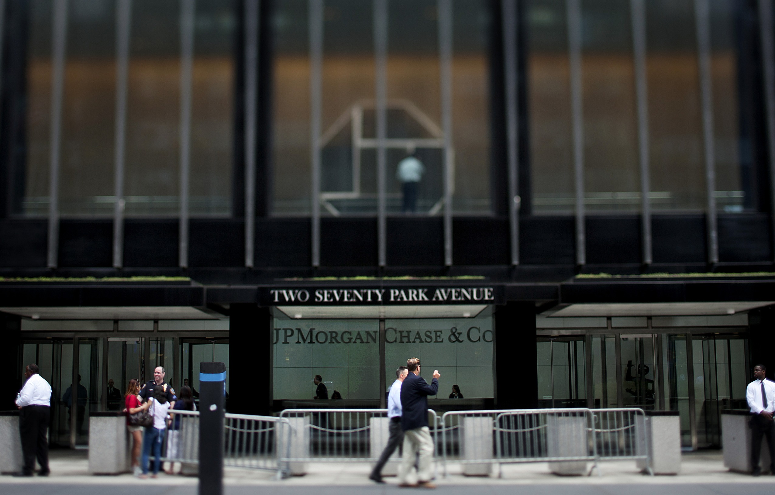 Pedestrians pass in front of the JPMorgan Chase & Co. headquarters in New York, U.S.