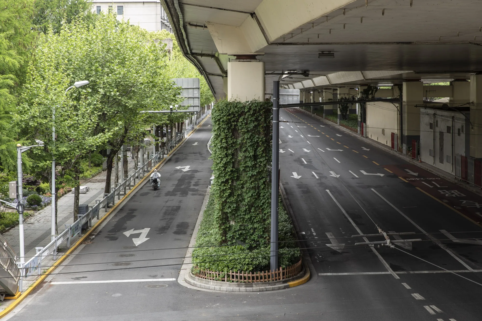 A worker in personal protective equipment&nbsp;travels along a near-empty road during a lockdown due to Covid-19 in Shanghai, China, on April 25.