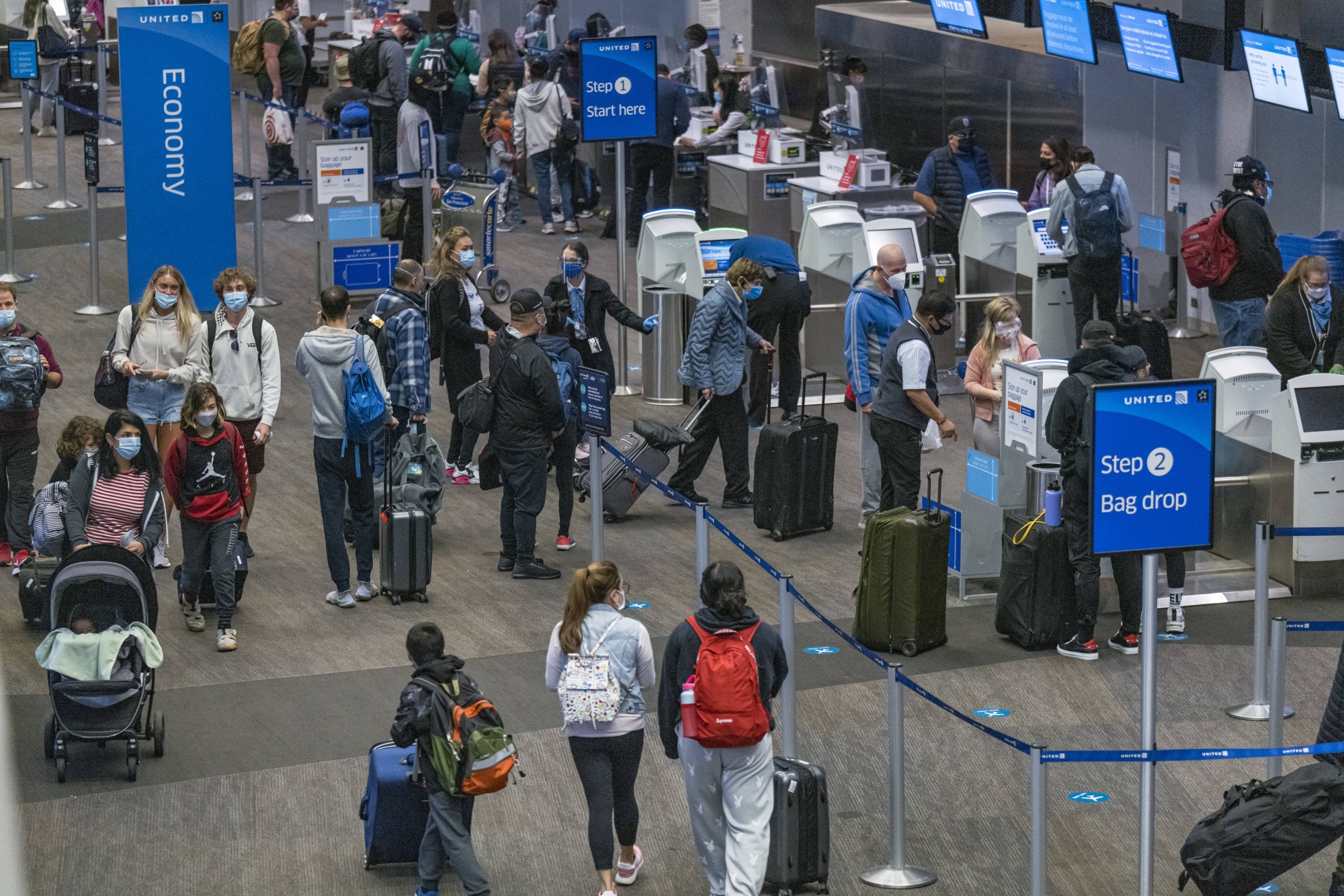 Travelers check in at a United Airlines check-in area at San Francisco International Airport (SFO) in San Francisco, California, on Monday.