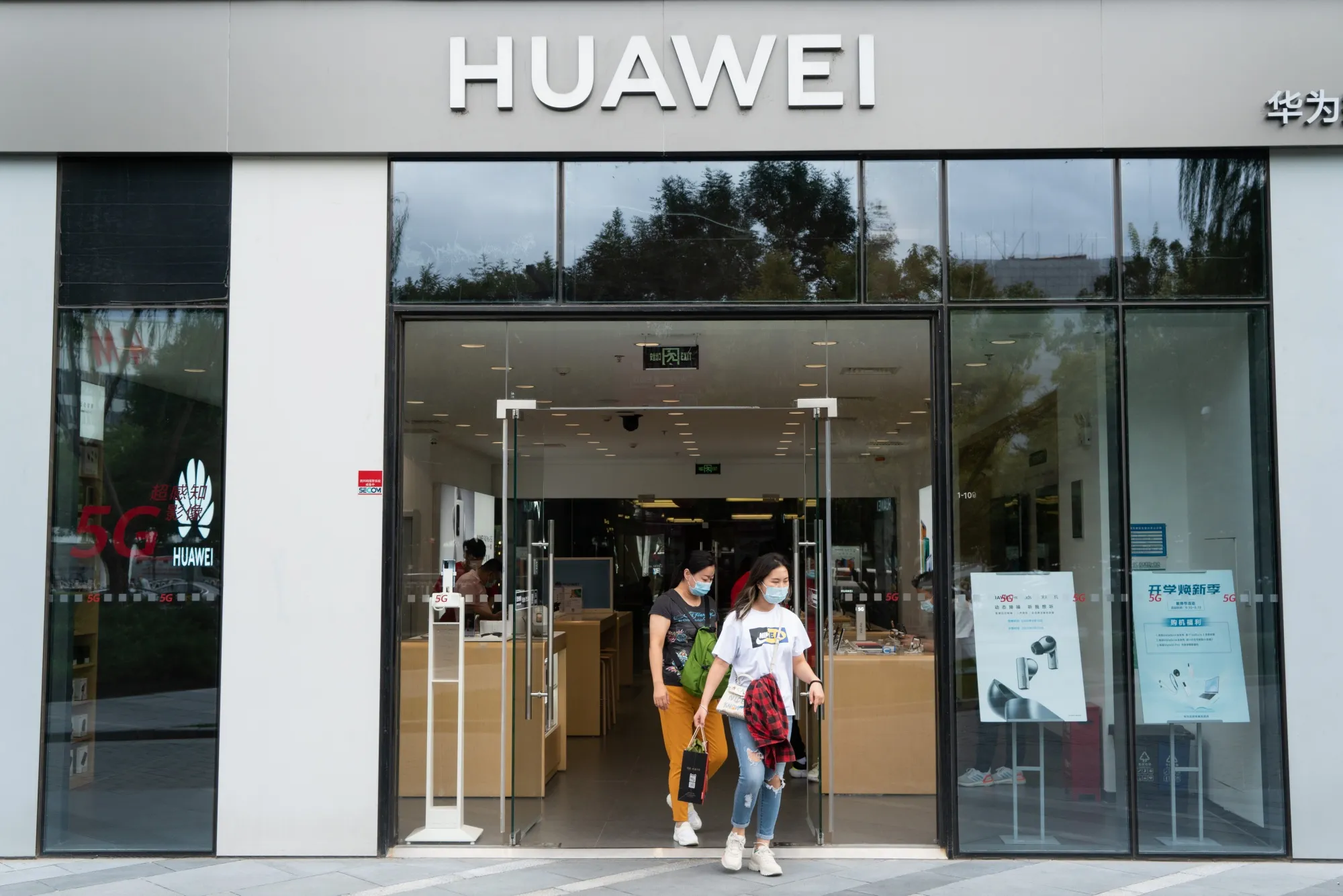 Customers exit a Huawei Technologies&nbsp;store in Beijing.
