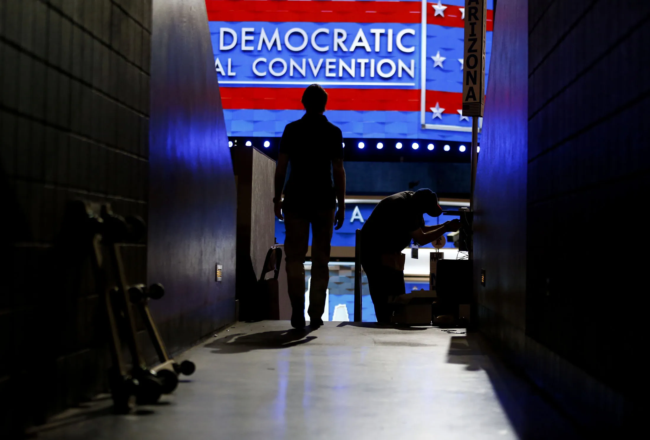 A worker installs wiring on the floor of the Wells Fargo Center ahead of the Democratic National Convention (DNC) in Philadelphia, Pennsylvania, U.S., on Sunday, July 24, 2016.
