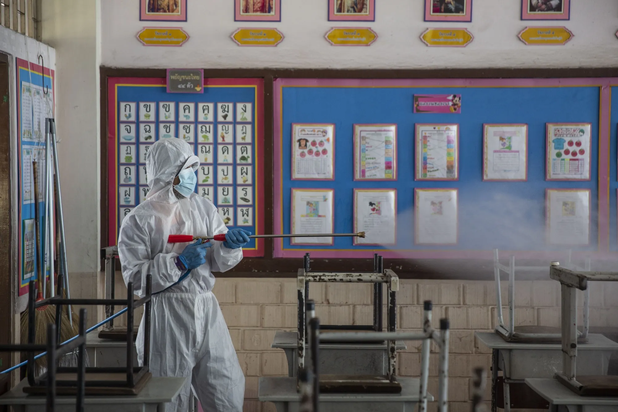 A Bangkok Metropolitan Authority employees disinfects a classroom during a cleaning day at San Chao School in Bangkok, on Jan. 29.