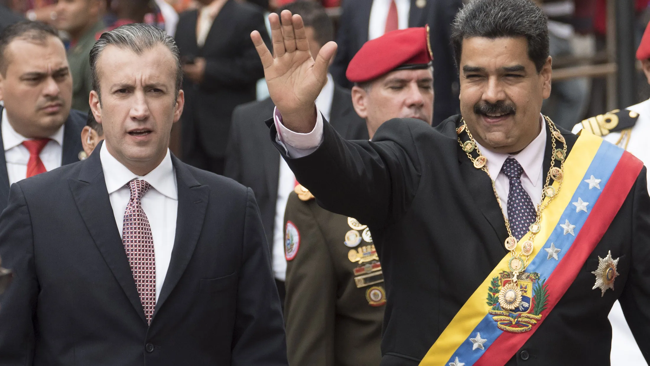 Nicolas Maduro, Venezuela's president, right, waves to attendees while accompanied by Tareck El Aissami, Venezuela's vice president, before the start of his annual address at the Supreme Court in Caracas on Jan. 15, 2017.
