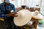 A milliner makes a hat in the Maison Michel workshop at the Chanel SA 19M campus in Aubervilliers, France.