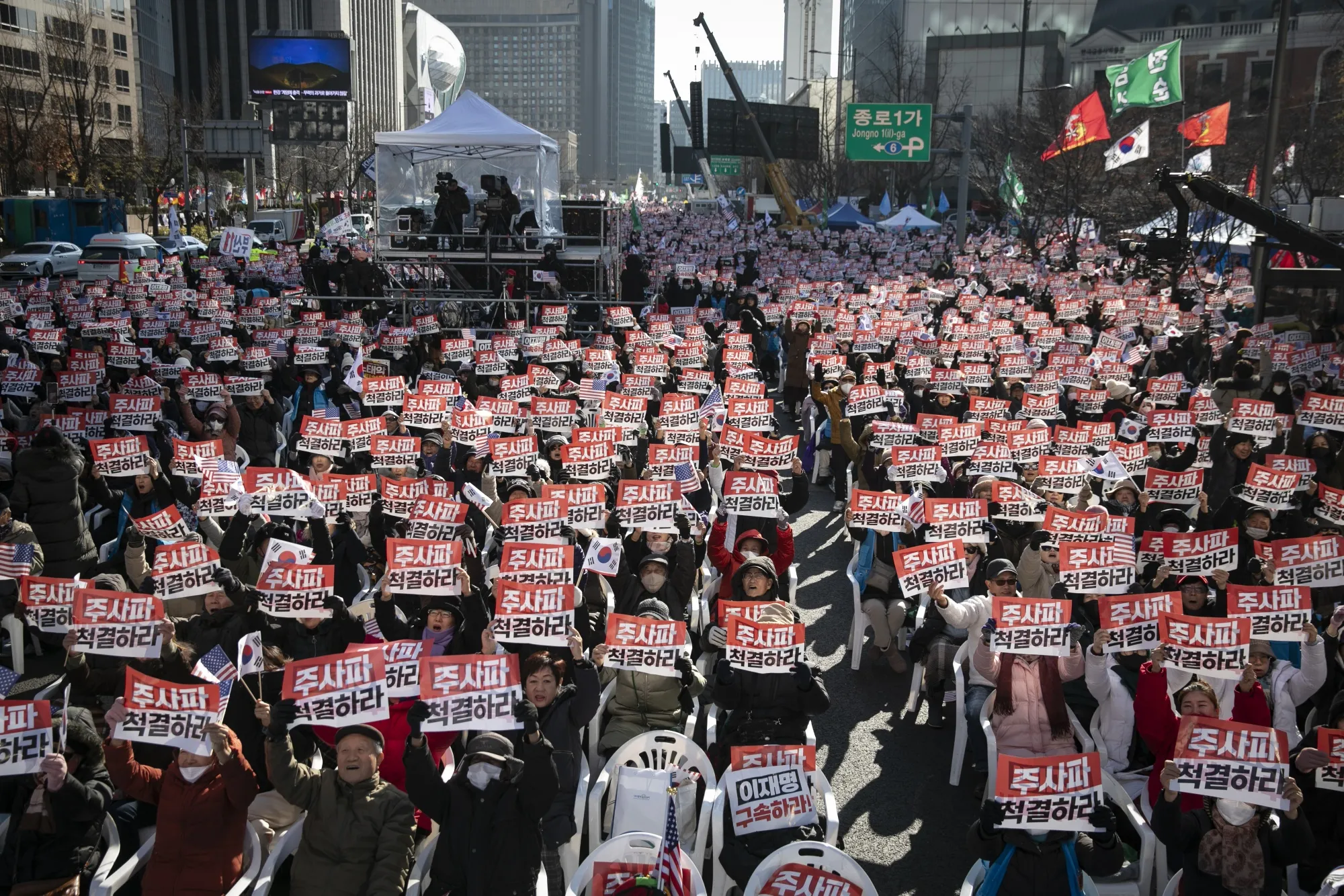 Supporters of Yoon Suk Yeol hold placards that read “Arrest Lee Jae-myung” during a rally at Gwanghwamun Square in Seoul, Dec. 7.