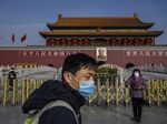 A Chinese couple wear masks as they visit the Tiananmen Gate before the Chinese New Year and Spring Festival on Jan. 24, 2020 in Beijing.