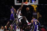 Philadelphia 76ers center DeAndre Jordan, center, dunks against Los Angeles Lakers guard Malik Monk (11) during the first half of an NBA basketball game in Los Angeles, Wednesday, March 23, 2022. (AP Photo/Ashley Landis)