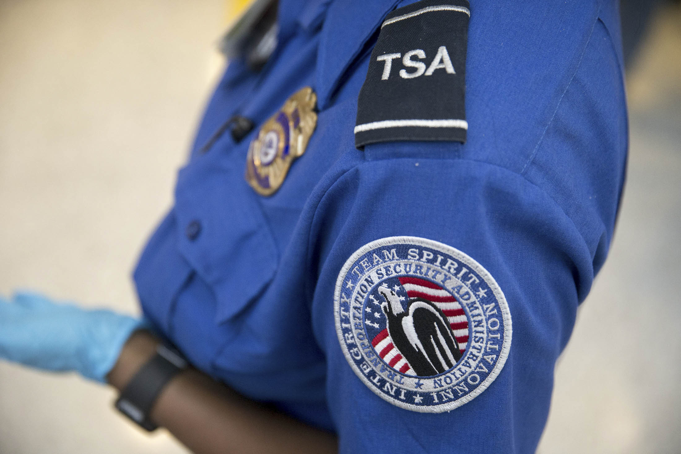 A Transportation Security Administration (TSA) officer stands in the TSA pre-check area at Dulles International Airport in Dulles, Va., on Aug. 19, 2015..
