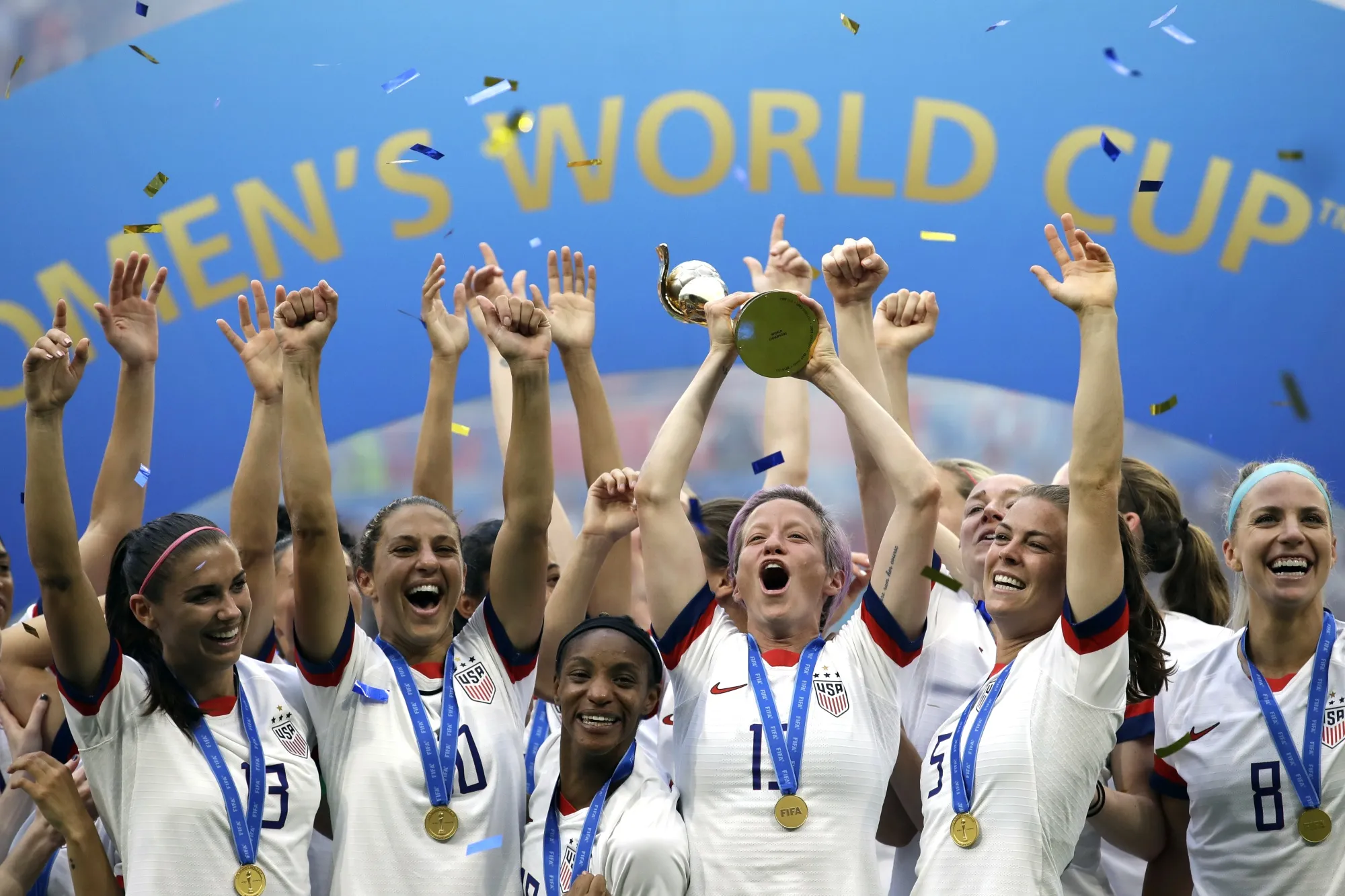United States' Megan Rapinoe lifts up the trophy after winning the Women's World Cup final soccer match between US and The Netherlands at the Stade de Lyon in Decines, outside Lyon, France, in July 7, 2019. (AP Photo/Alessandra Tarantino, File)