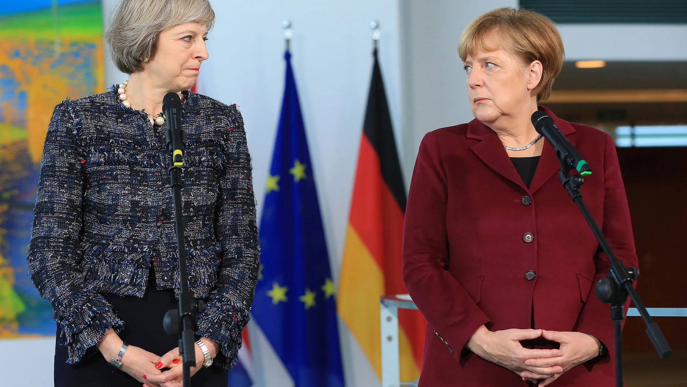 Theresa May, U.K. prime minister, and Angela Merkel, Germany's chancellor, pause during a news conference at the Chancellery in Berlin on Nov. 18, 2016.
