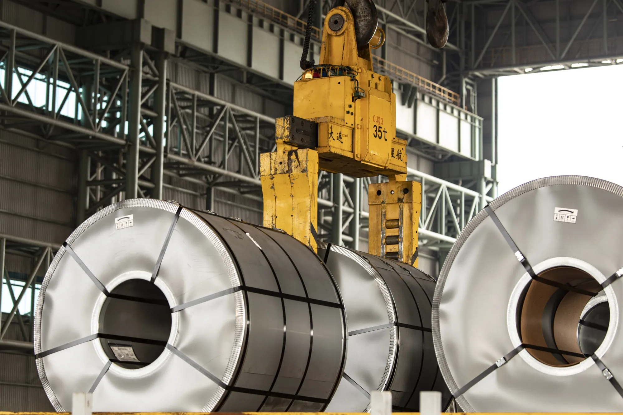 Rolls of steel on the transport wharf at Baowu Steel Group Co.'s Baoshan production facility in Shanghai, China.