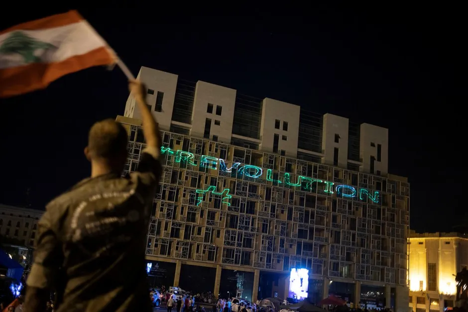 The word "Revolution" is projected on a building during a protest in downtown Beirut, October 22, 2019.