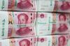 Genuine bundles of Chinese one-hundred yuan banknotes are arranged for a photograph at the Counterfeit Notes Response Center of KEB Hana Bank in Seoul, South Korea.