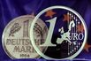 Ready for the detachment,,, A 1 Euro and a 1 DM coin in front of a European flag.