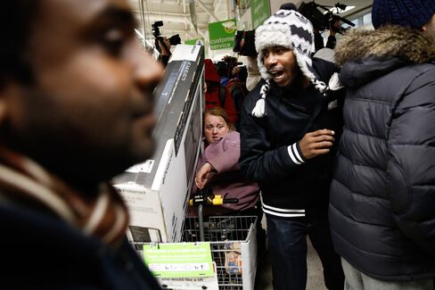 Customers scramble for Black Friday deals at an Asda supermarket in London on Nov. 28, 2014.