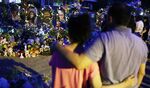People visit a memorial for victims of the mass shooting at Robb Elementary School in Uvalde, Texas.