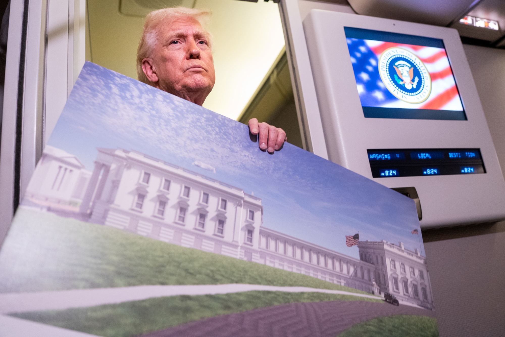 US President Donald Trump holds a rendering of the proposed East Wing of the White House while speaking to members of the media on Air Force One on March 29. Photographer: Nathan Howard/Getty Images