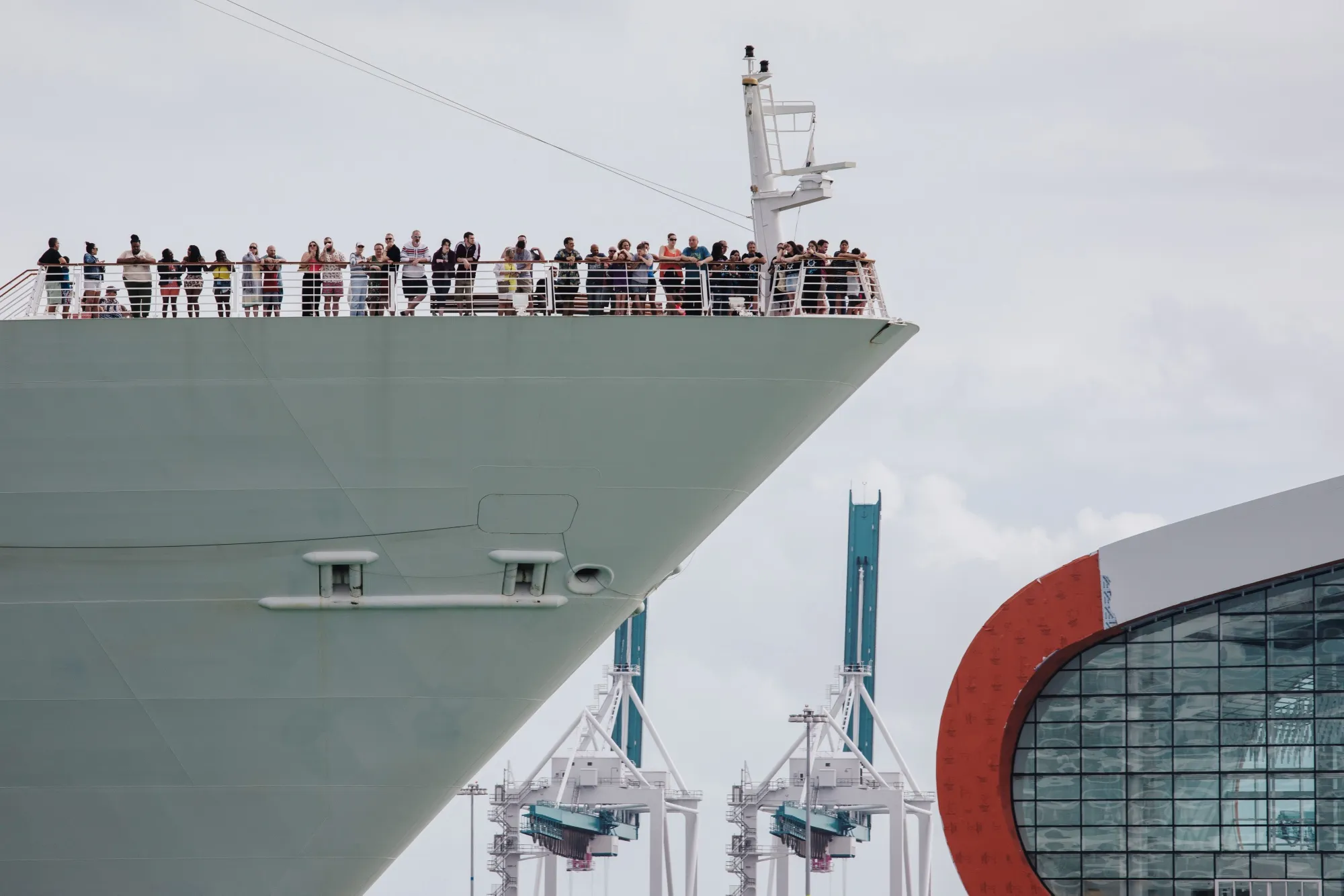 Passengers stand on board the Royal Caribbean's Navigator Of The Seas cruise ship at the Port of Miami on March 9.