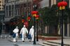 Volunteers in isolation gowns walk to send groceries to residents in home quarantine in Wuhan on Feb. 20.