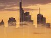 EDITORS NOTE: Multiple exposures were combined in camera to produce this image. An image of clouds at sunset overlays the skyscraper skyline of the financial district in Frankfurt, Germany, on Monday, July 1, 2019. Following the collapse of merger talks between Deutsche Bank and Commerzbank, German Finance Minister Olaf Scholz changed his message from supporting a national champion to backing a cross-border merger.