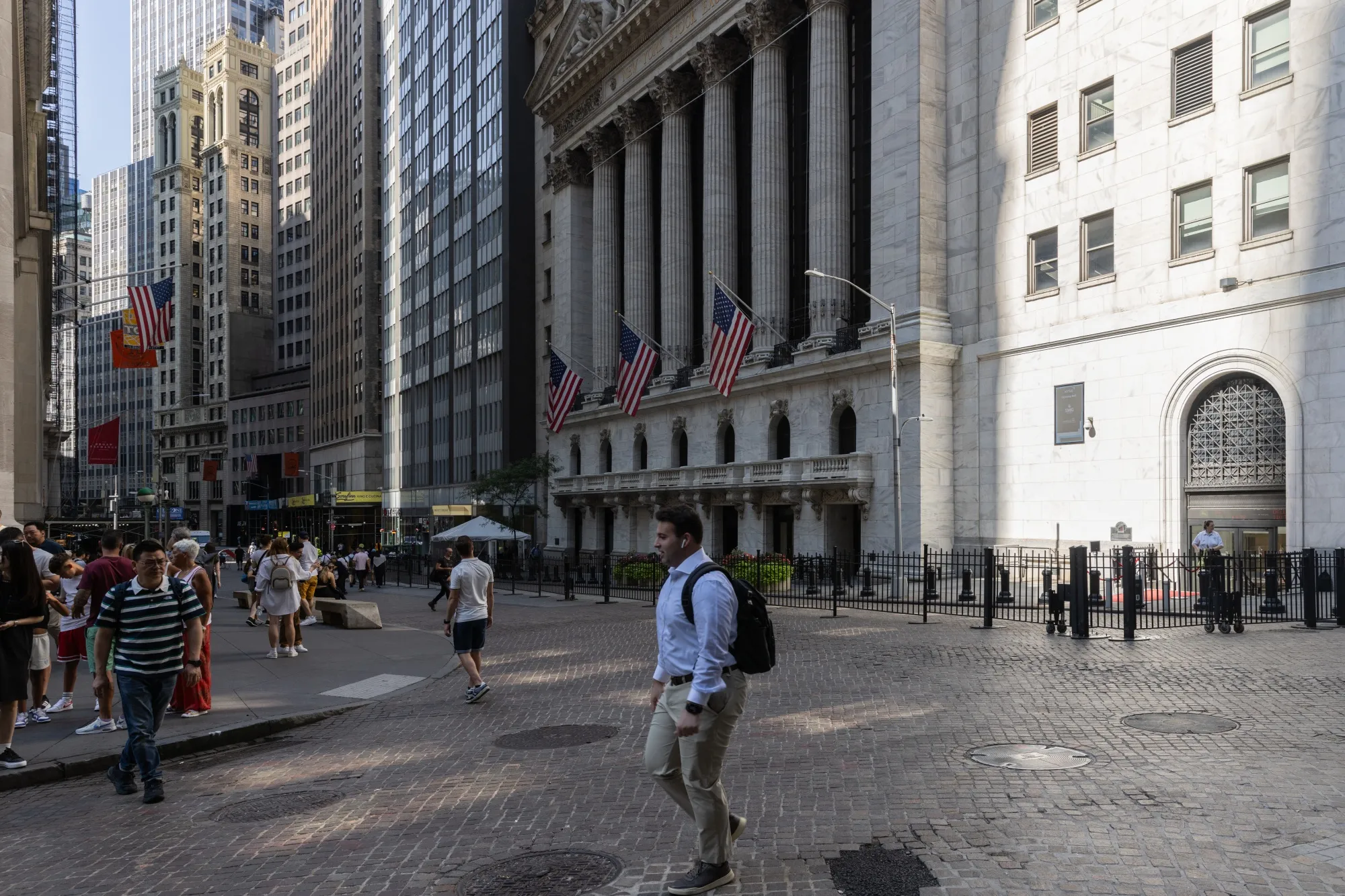 Pedestrians walk along Wall Street near the New York Stock Exchange (NYSE) in New York&nbsp;on Aug. 27, 2024.&nbsp;