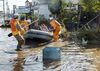 Fire department workers evacuate residents from a flooded area in Date, Fukushima prefecture on October 13, 2019, one day after Typhoon Hagibis swept through central and eastern Japan.