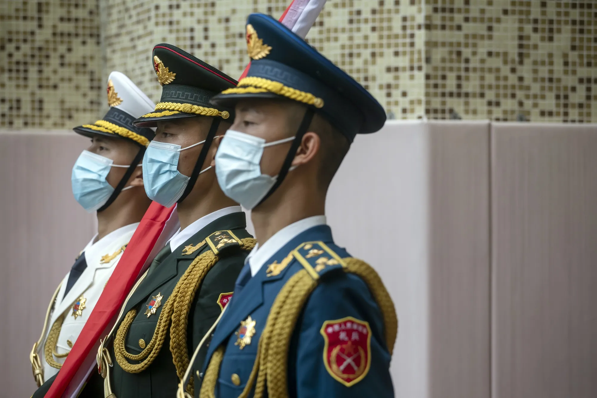 Members of the People’s Liberation Army&nbsp;honor guard hold a Chinese national flag during a flag-raising ceremony in 2021 to mark the 24th anniversary of Hong Kong’s return to Chinese rule.
