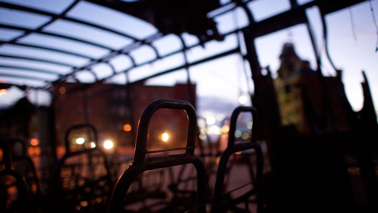 The remains of a senior center bus set ablaze during night riots are seen at dawn on April 28, 2015 in Baltimore, Maryland.
