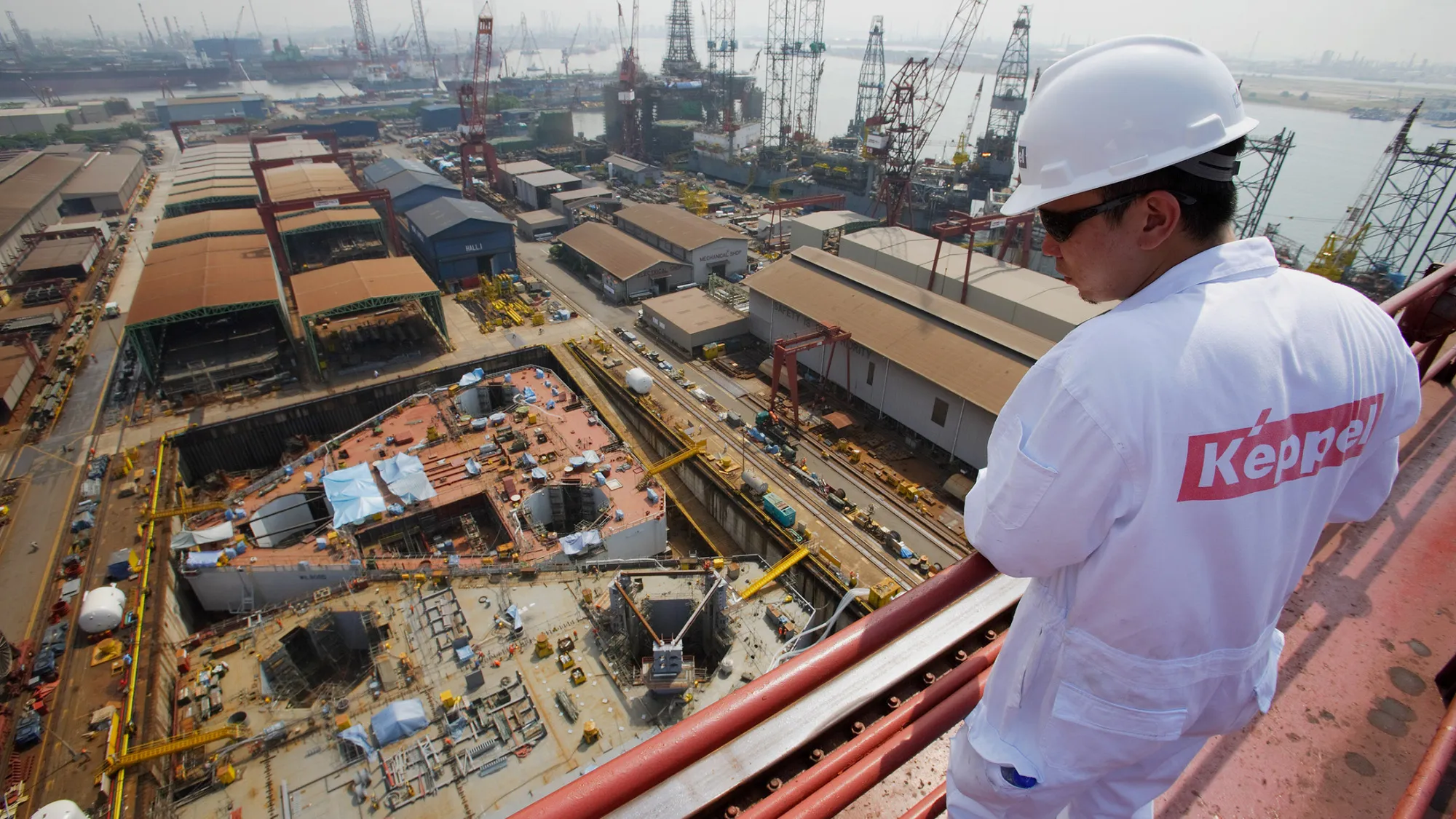 A Keppel Corp. employee looks down at the company's drydock. Photographer: Jonathan Drake/Bloomberg
