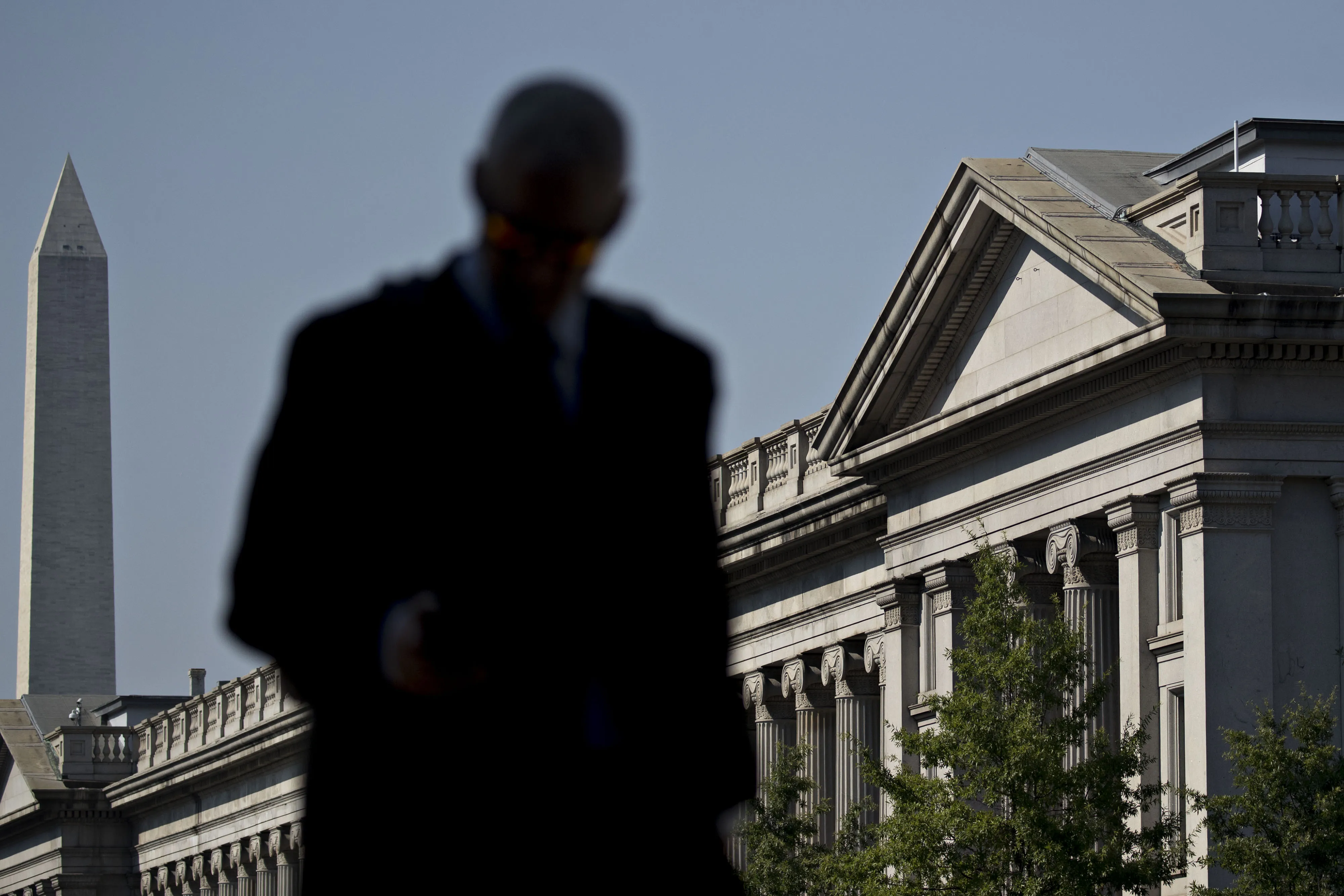 A pedestrian walks near the U.S. Treasury building in Washington, D.C.
