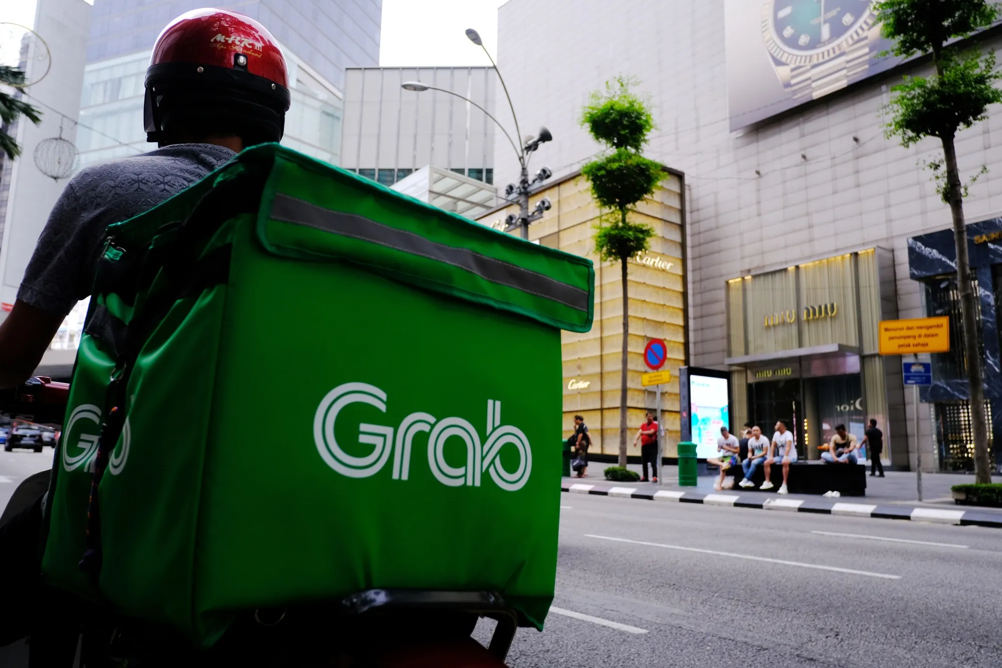 A Grab Holdings Inc. driver waits for an order in the Bukit Bintang district of Kuala Lumpur, Malaysia.