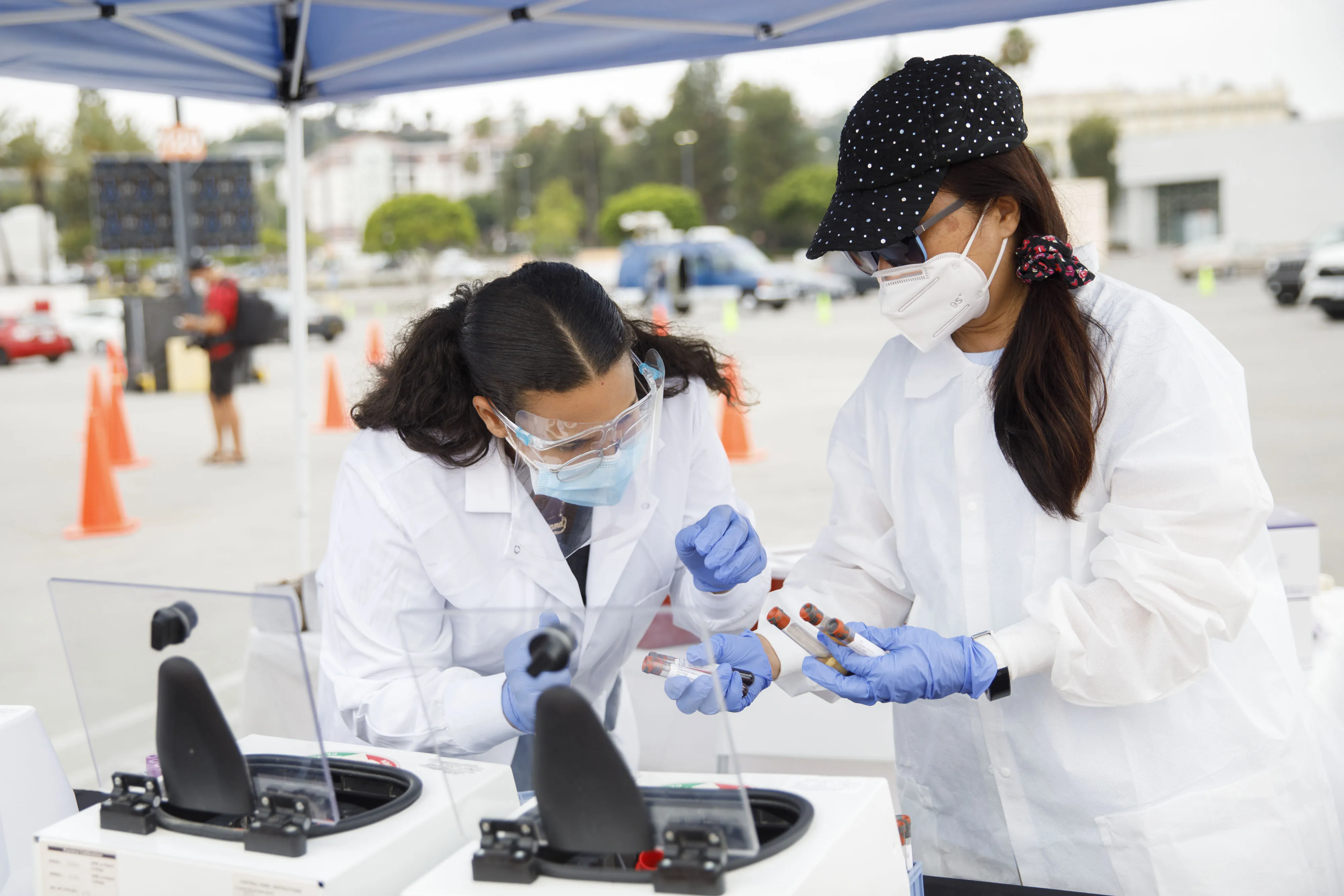 Phlebotomists place Covid-19 antibody test blood samples into a centrifuge at a&nbsp;testing site in Los Angeles, California, on Aug. 5.