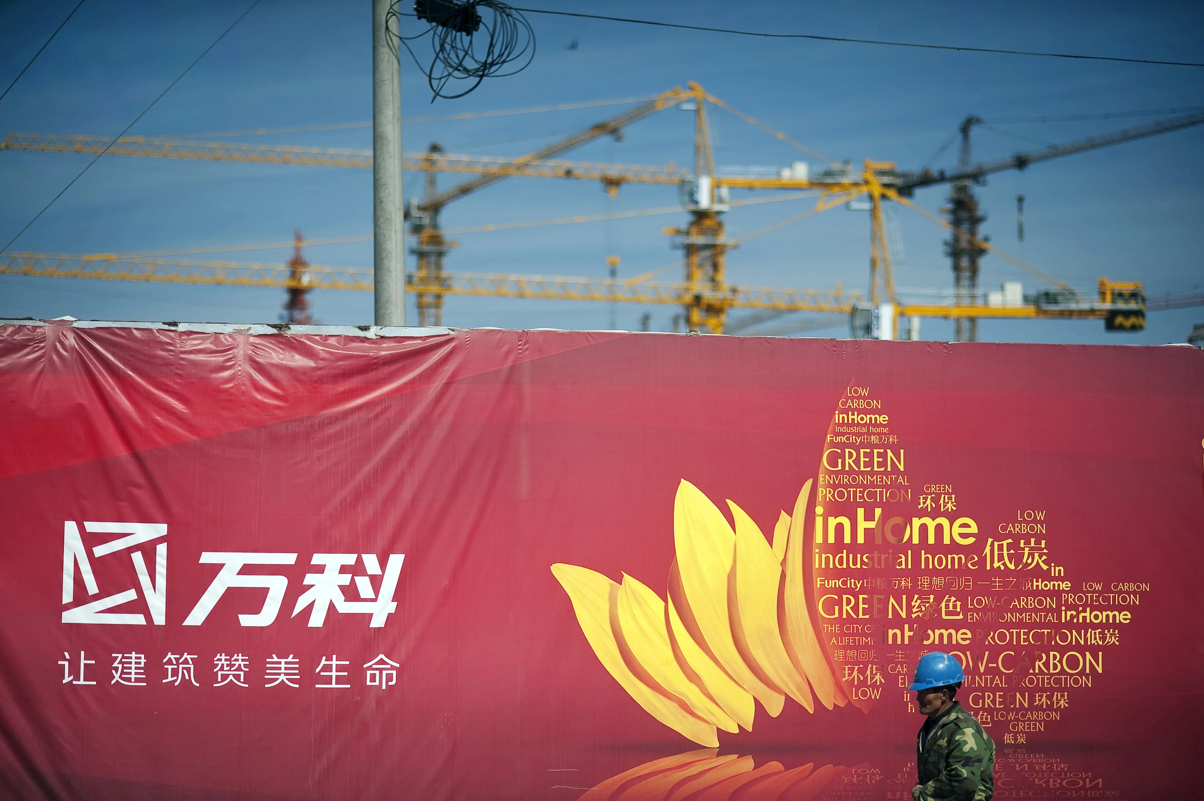 A construction worker leaves the site of China Vanke's "Fun City" apartment complex in the Fangshan district on the outskirts of Beijing.
