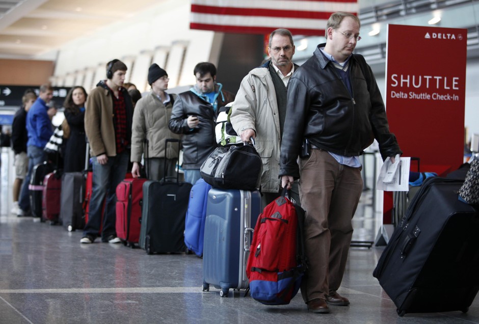 Passengers wait to check in at Logan International Airport in Boston, December 21, 2009.