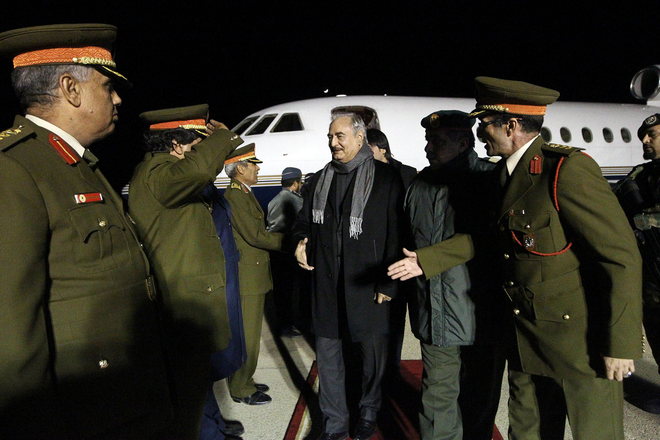 General Khalifa Haftar, center, commander of the armed forces loyal to the internationally recognised Libyan government, is greeted upon his arrival at Al-Kharouba airport south of the town of al-Marj on Dec. 3, 2016.
