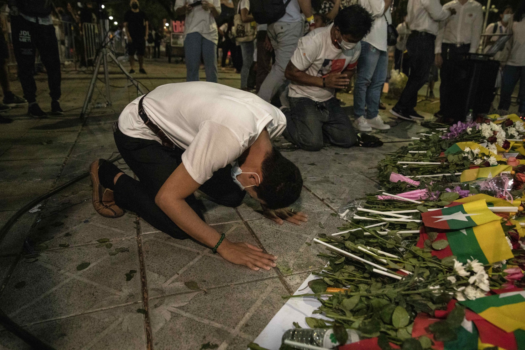 Demonstrators lay flags and flowers during a protest outside the United Nations Building in Bangkok, Thailand, in&nbsp;March 2021. The UN says more than 1,500 civilians including&nbsp;young children have been killed by the military junta that seized power last year.