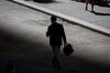 A man walks along Wall Street near the New York Stock Exchange (NYSE).