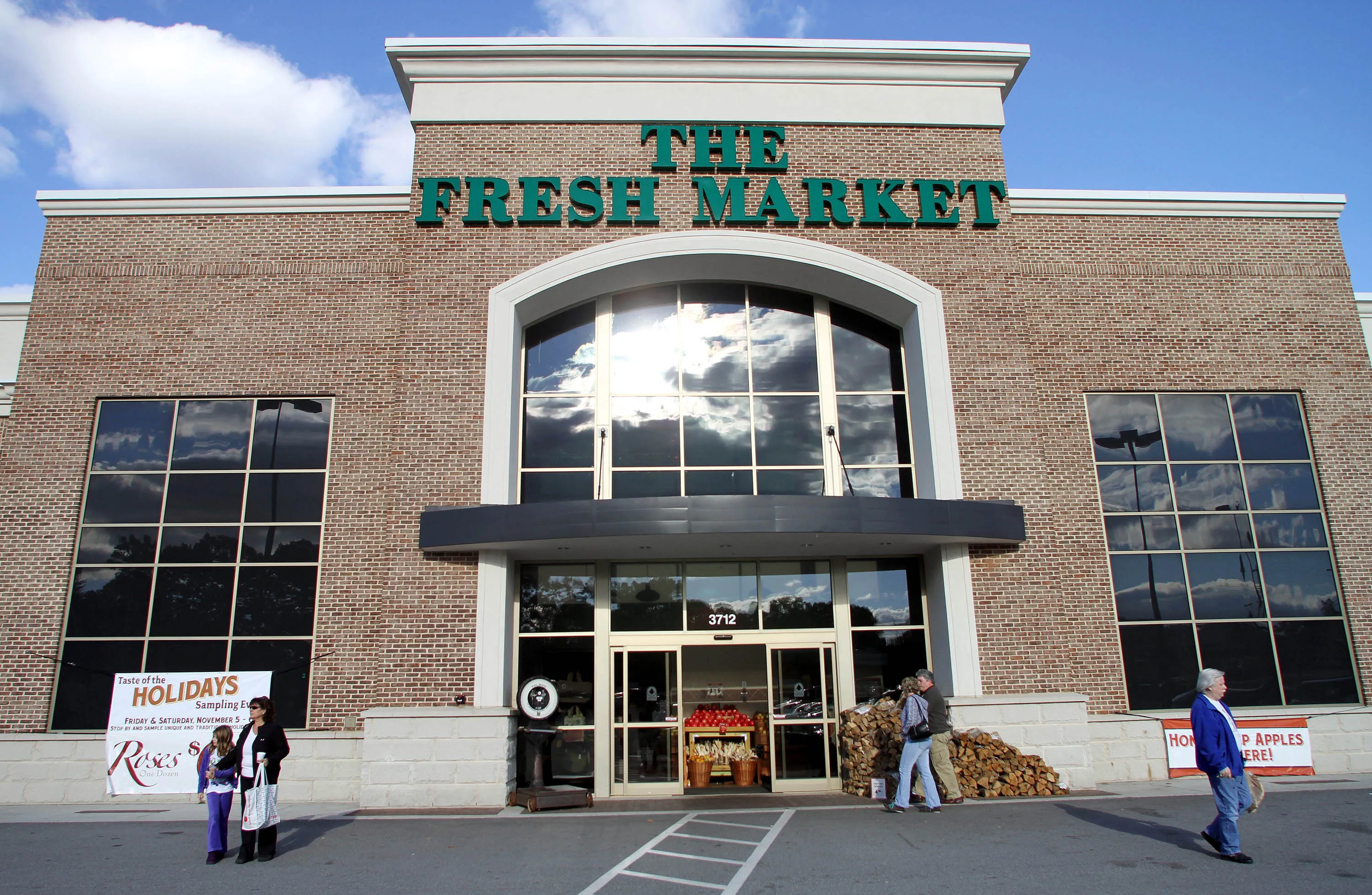 Customers outside a Fresh Market store.