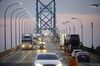 Commercial trucks and passenger vehicles drive across Ambassador Bridge on the Canada-U.S. border in Windsor, Ontario, Canada, on Thursday, Aug. 9, 2018. The Ambassador Bridge connects Canada to USA, from Windsor to Detroit and facilitates over 30% of all Canada-US road trade.