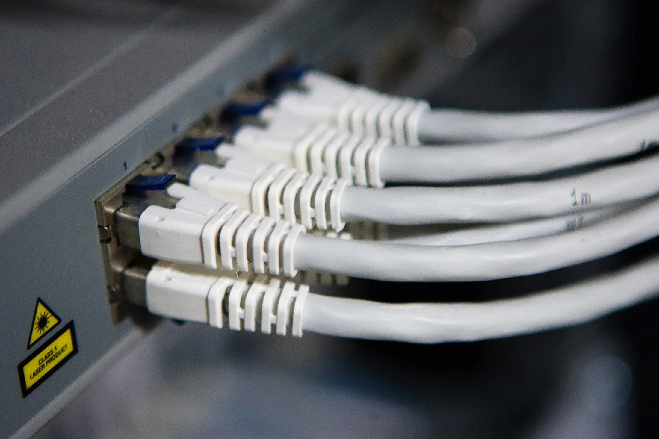 Computer network cables sit connected to server machines at Portugal Telecom SGPS SA's new data center in Covilha, Portugal, on Thursday, Oct. 10, 2013. Oi SA's merger with Portugal Telecom is likely to bolster Brazil's largest landline phone carrier as it battles better-equipped rivals in the world’s fifth-biggest wireless market.
